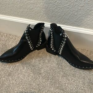 Black leather ankle boots with silver metal accents. Never worn.